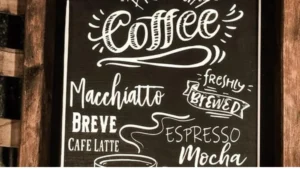 A coffee shop sign with a unique, catchy name above a cozy storefront, representing the impact of a well-chosen Coffee Shop Business Name.