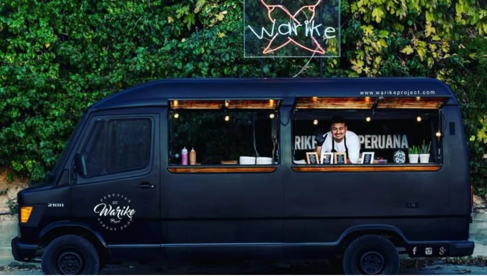 A vibrant food truck serving customers on a busy city street, representing the growing popularity of the food truck business.