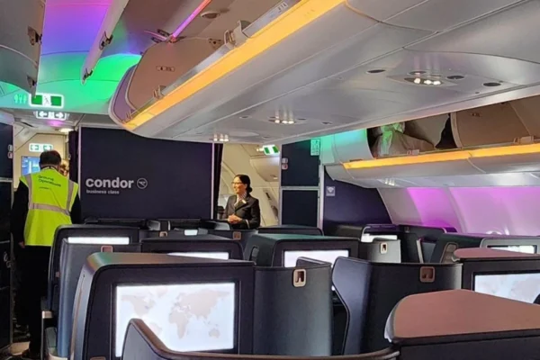 "Condor Airlines Business Class seat with spacious legroom and luxury amenities onboard"