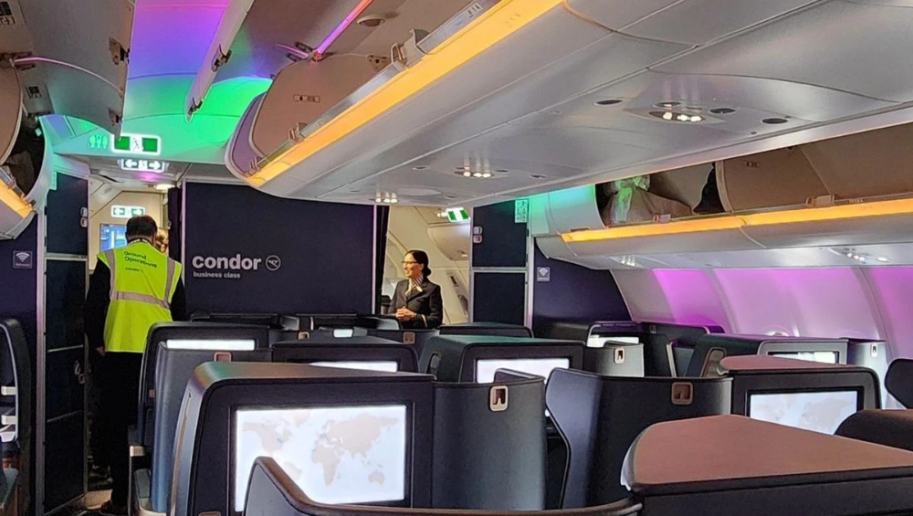 "Condor Airlines Business Class seat with spacious legroom and luxury amenities onboard"