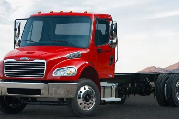 "Freightliner Business Class M2 truck parked on a construction site, showcasing its rugged design and utility features"
