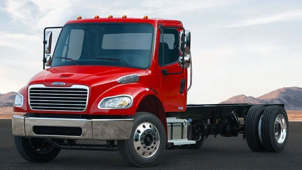 "Freightliner Business Class M2 truck parked on a construction site, showcasing its rugged design and utility features"