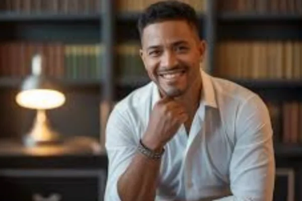 "Mariano Iduba speaking at an event, wearing a tailored suit and engaging with the audience"