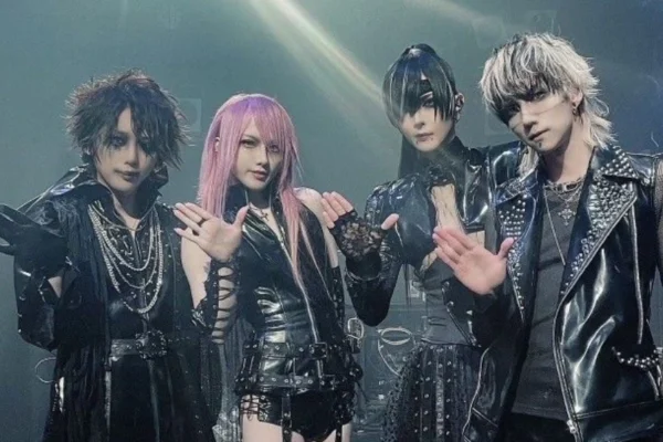 "Person wearing Vkei fashion with dramatic makeup, spiked hair, layered clothing, and punk-gothic accessories"