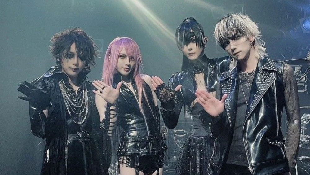 "Person wearing Vkei fashion with dramatic makeup, spiked hair, layered clothing, and punk-gothic accessories"