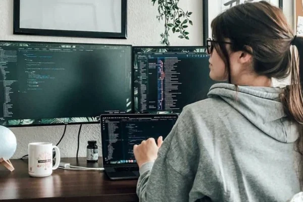 A young girl learning to code on a laptop during a girls in tech workshop.