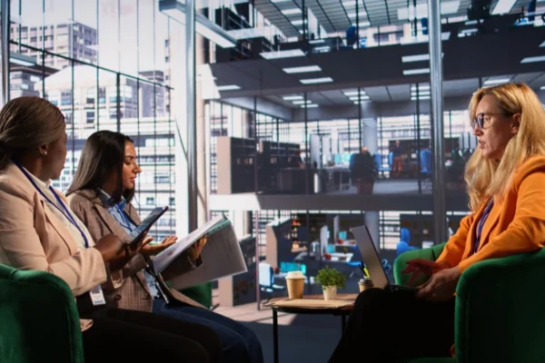 Business professionals and university researchers collaborating in a modern innovation hub, showcasing AHRC business links partnerships for creative sector growth
