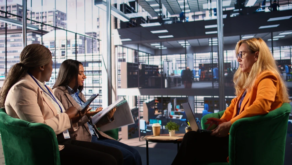 Business professionals and university researchers collaborating in a modern innovation hub, showcasing AHRC business links partnerships for creative sector growth