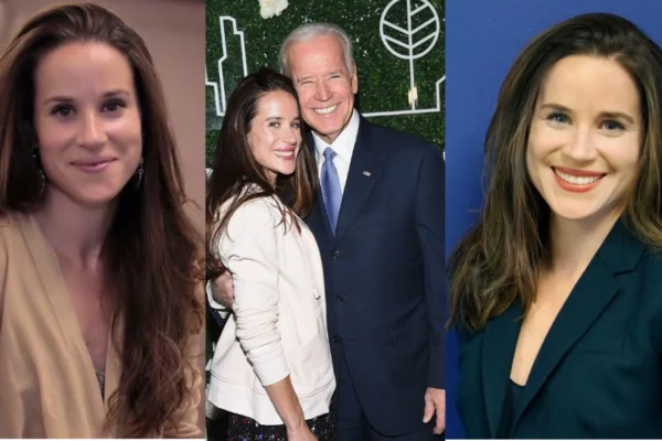 Ashley Biden standing at a podium during a public event, wearing a professional outfit and smiling warmly.