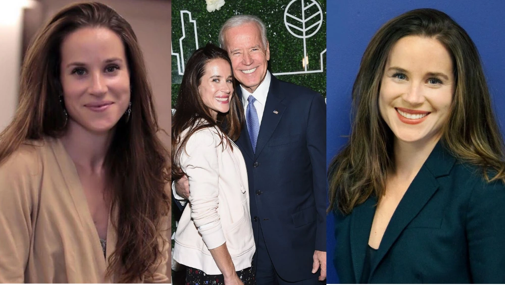 Ashley Biden standing at a podium during a public event, wearing a professional outfit and smiling warmly.