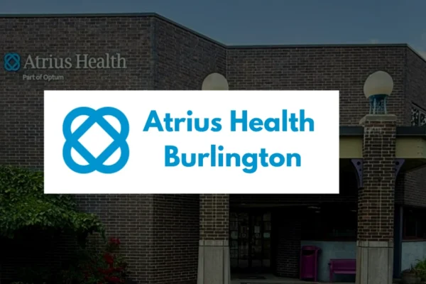 Front exterior of the Atrius Health Burlington medical facility at 20 Wall Street, showing the modern building entrance and clear signage under a blue sky.