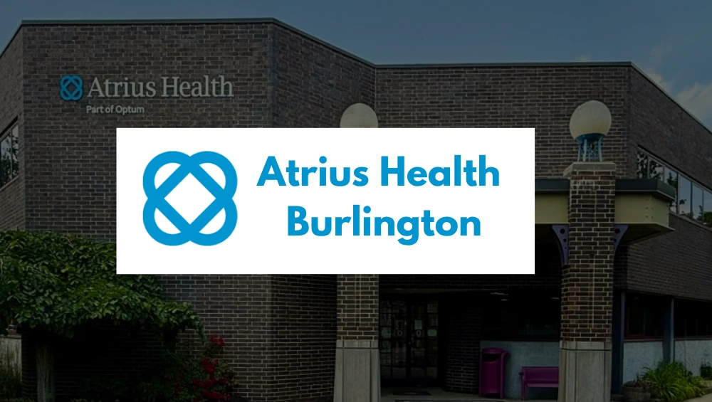 Front exterior of the Atrius Health Burlington medical facility at 20 Wall Street, showing the modern building entrance and clear signage under a blue sky.
