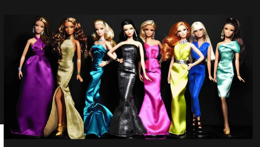 A lineup of Barbie Fashionista dolls showcasing diverse styles, body types, and fashion trends on a brightly lit display shelf.