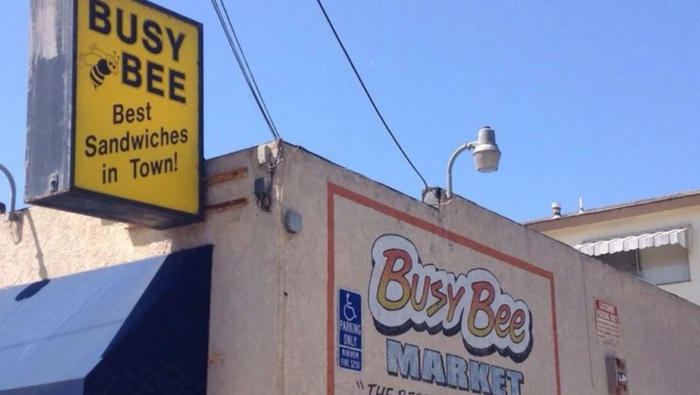 Exterior of Busy Bee San Pedro, a classic American diner with vintage signage and outdoor seating.