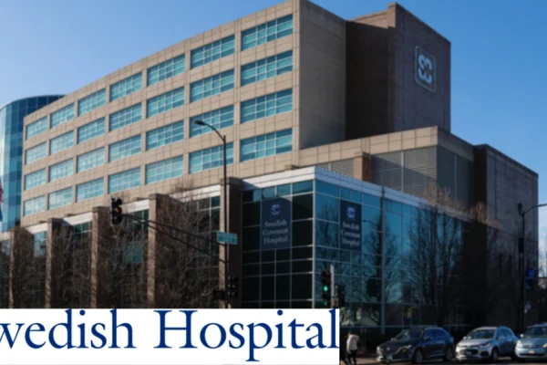 Exterior facade of Endeavor Health Swedish Hospital, a multi‑story medical campus on Chicago’s North Side, under a bright blue sky.
