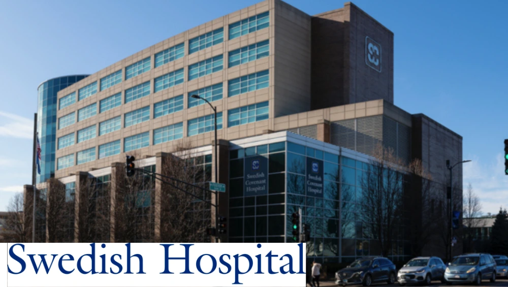 Exterior facade of Endeavor Health Swedish Hospital, a multi‑story medical campus on Chicago’s North Side, under a bright blue sky.