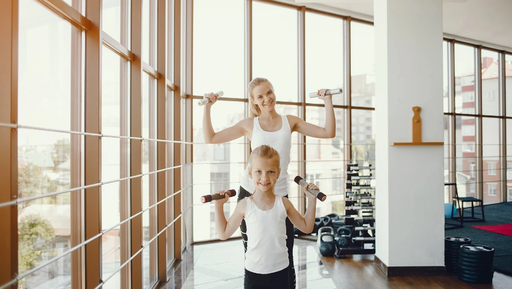 Students and athletes enjoying activities inside Gregory Gym at UT Austin, showcasing the gym’s vibrant fitness and sports environment near UT Tower.