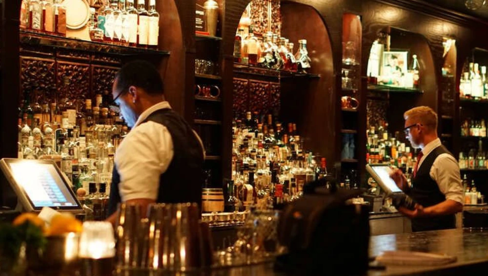 Cozy interior of Herbs and Rye Las Vegas with classic cocktails and elegant vintage decor.
