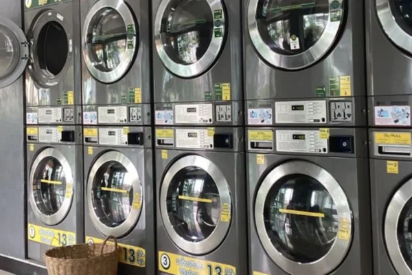 Interior view of a self-service laundromat with washers and dryers, part of a laundromat business for sale.