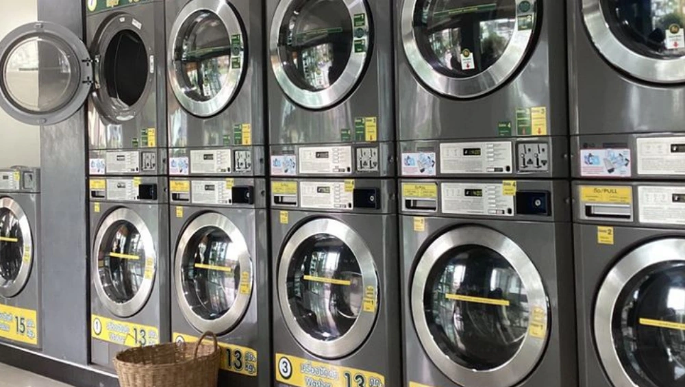 Interior view of a self-service laundromat with washers and dryers, part of a laundromat business for sale.