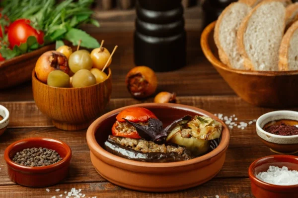 Traditional pollaste dish served on rustic Mediterranean table with herbs, olive oil, and colorful vegetables showcasing authentic Spanish cooking