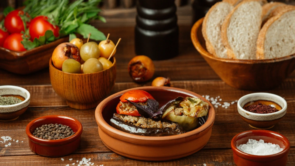 Traditional pollaste dish served on rustic Mediterranean table with herbs, olive oil, and colorful vegetables showcasing authentic Spanish cooking