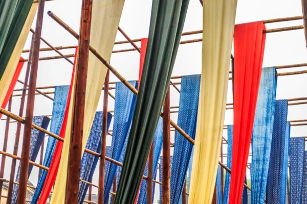 Different types of markiseteppe awning fabrics displayed on balconies and terraces showing various colors and materials